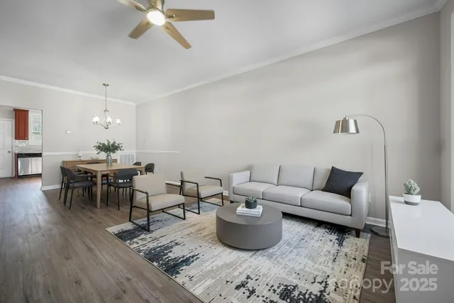a living room with furniture a rug and a chandelier