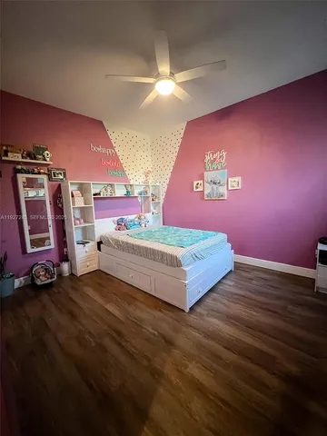 a spacious bedroom with a bed and a walk in closet