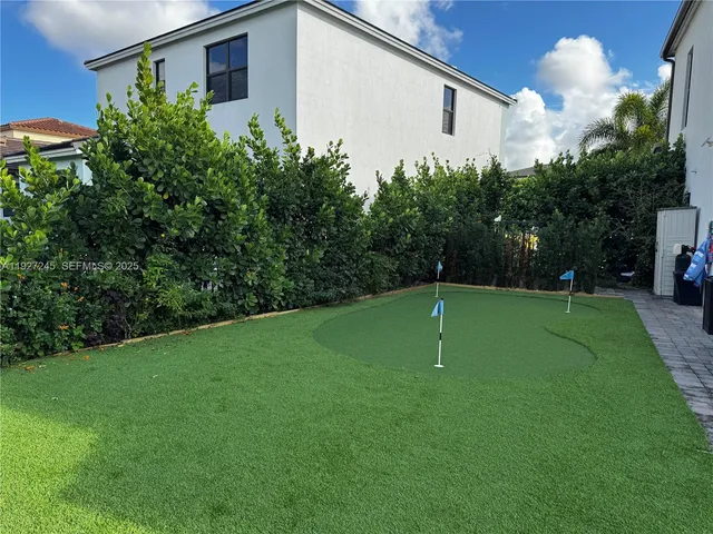 a backyard of a house with plants and a garden
