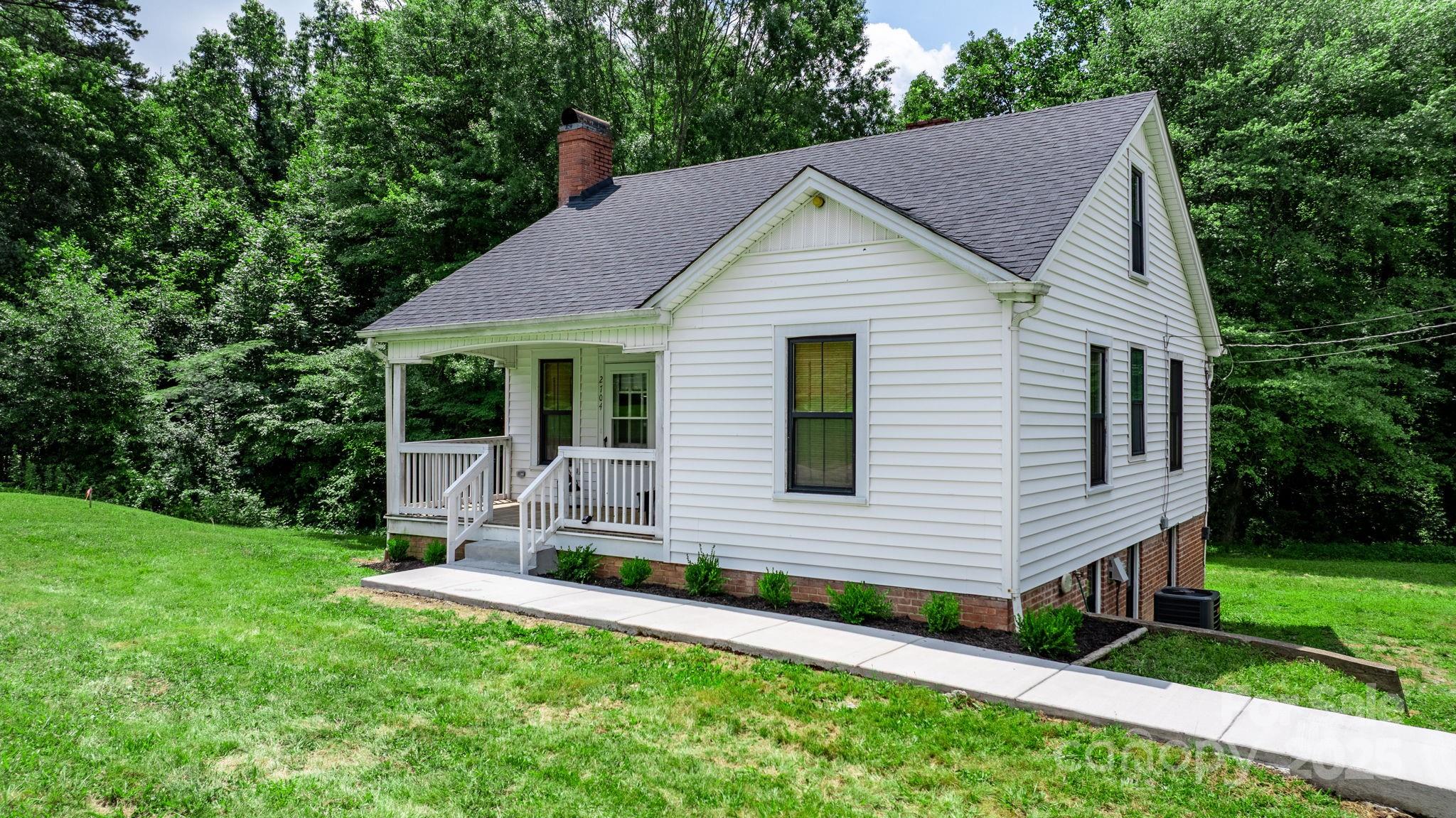 a front view of house with backyard and green space
