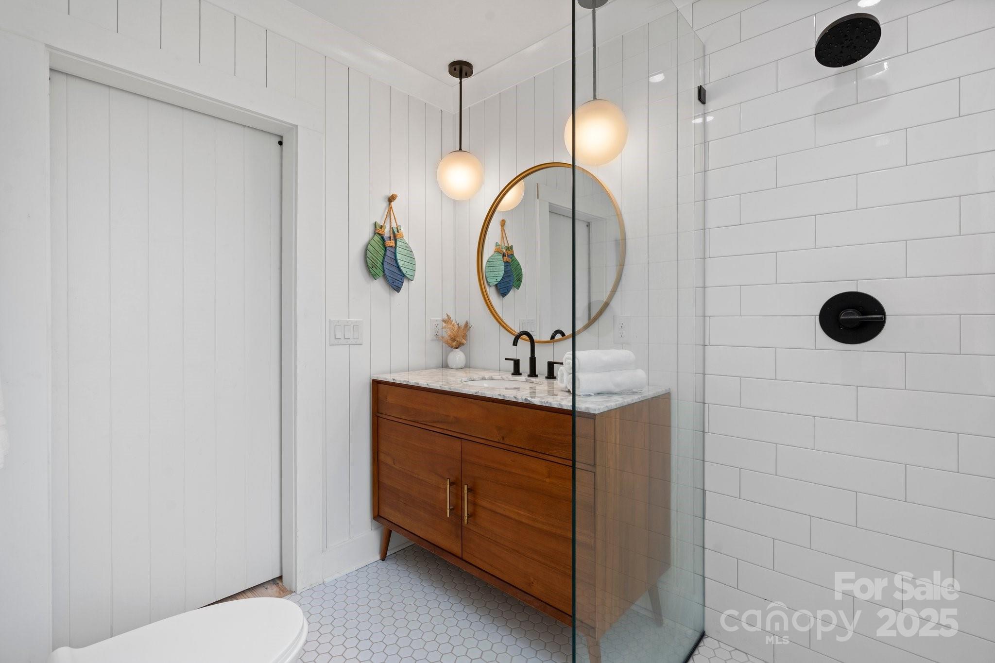 2704 Kool Park Road Northeast Hickory, NC 28601 - Photo 13 of 23 a bathroom with a sink a light fixture and a mirror