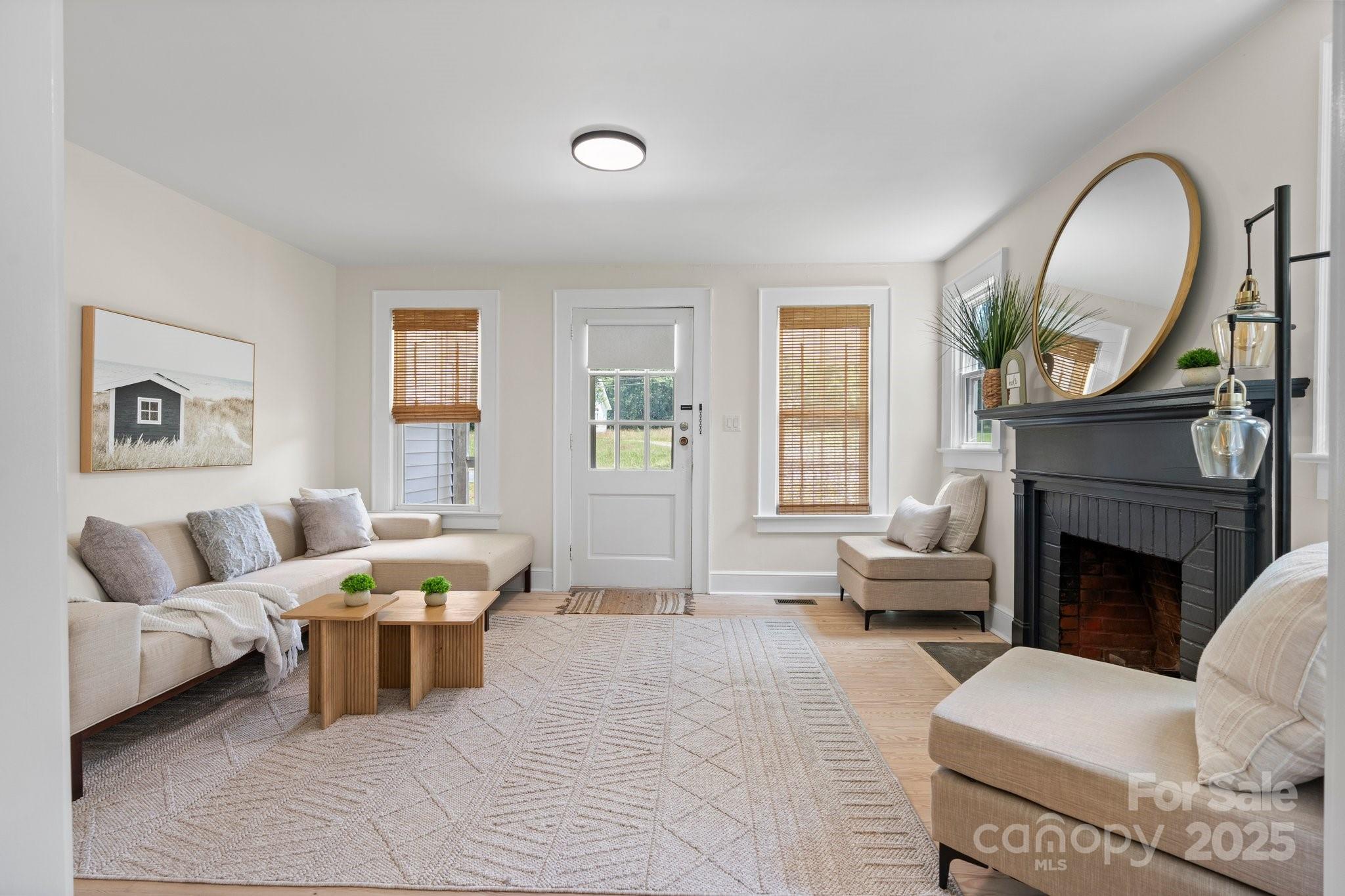 2704 Kool Park Road Northeast Hickory, NC 28601 - Photo 2 of 23 a living room with furniture a fireplace and a large window