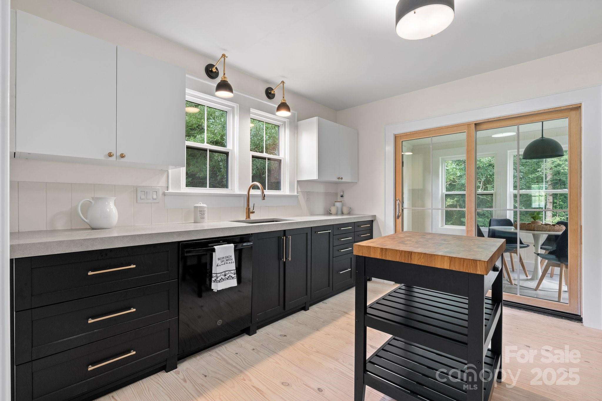 2704 Kool Park Road Northeast Hickory, NC 28601 - Photo 5 of 23 a kitchen with a table chairs sink and cabinets