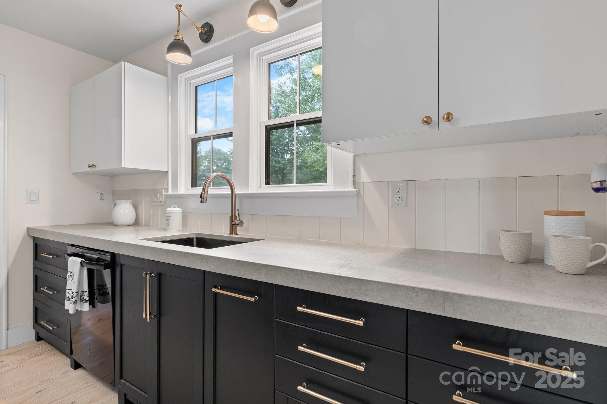 2704 Kool Park Road Northeast Hickory, NC 28601 - Photo 7 of 23 a kitchen with a sink a window and cabinets