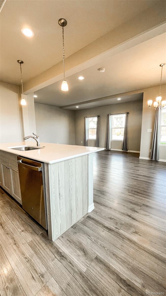 7935 Shilo Mesa Drive Colorado Springs, CO 80908 - Photo 12 of 30 a kitchen with stainless steel appliances granite countertop a sink a stove and a wooden floors