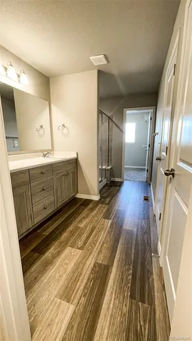 a view of an empty room and wooden floor