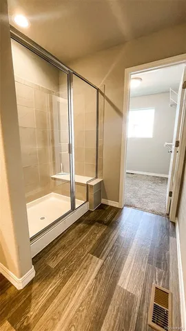 a spacious bathroom with double vanity and a mirror
