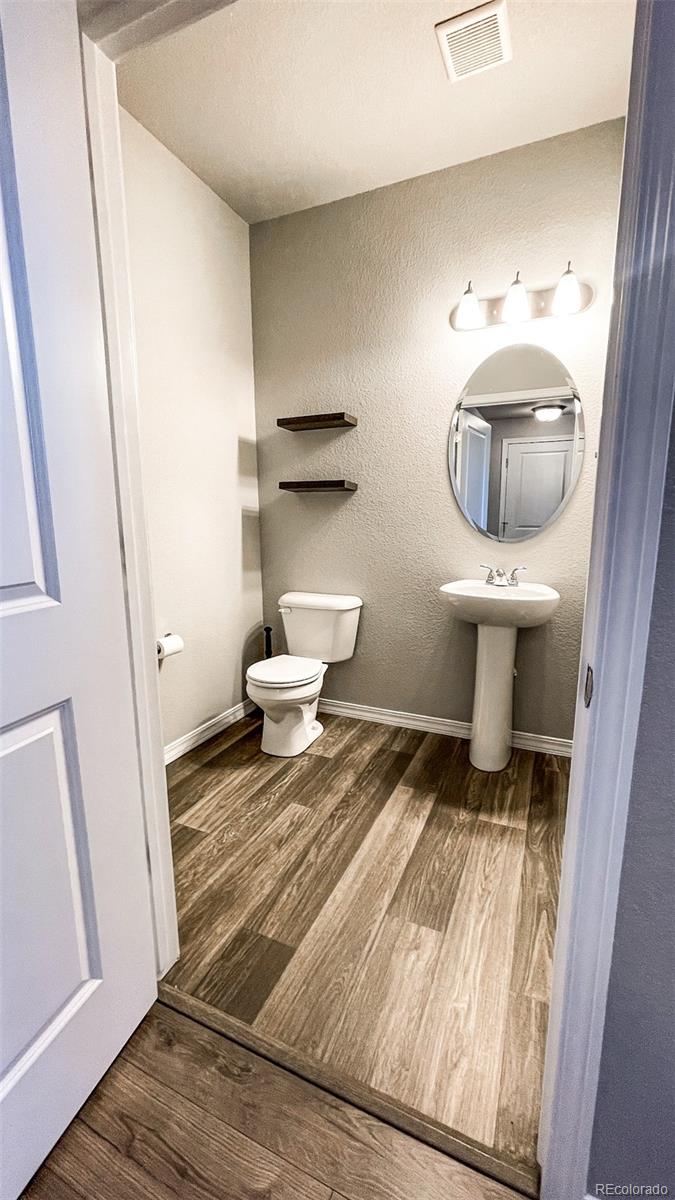 7935 Shilo Mesa Drive Colorado Springs, CO 80908 - Photo 24 of 30 a bathroom with a toilet and a sink