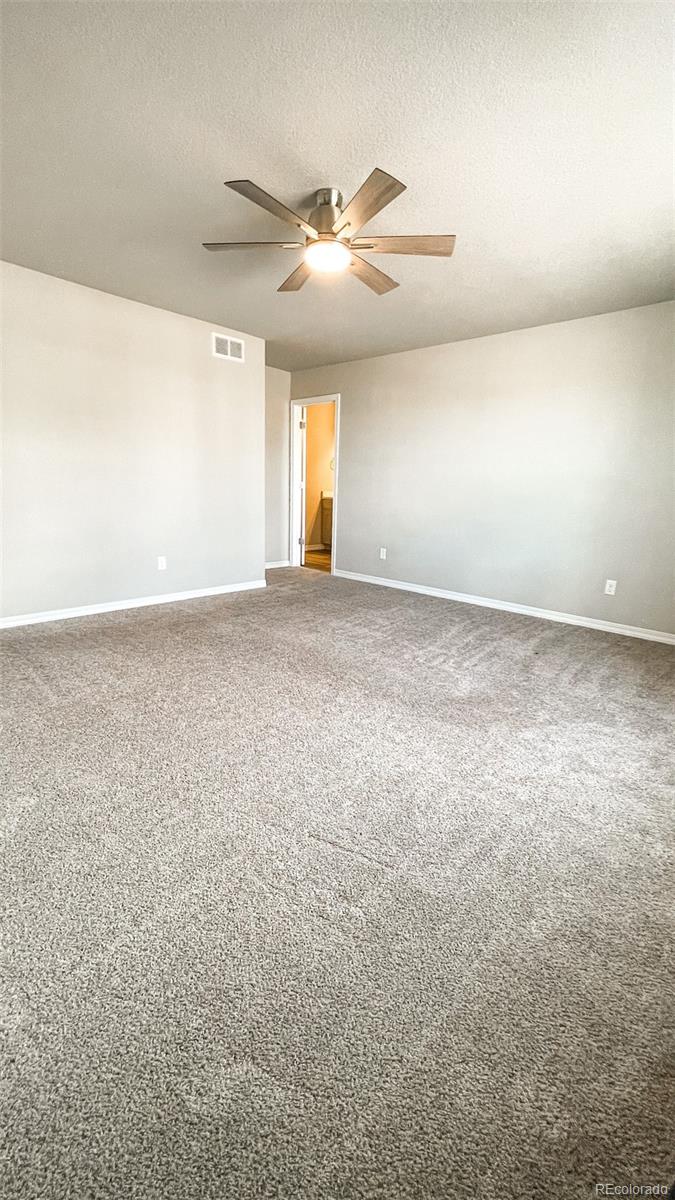 7935 Shilo Mesa Drive Colorado Springs, CO 80908 - Photo 7 of 30 an empty room with a empty space and windows