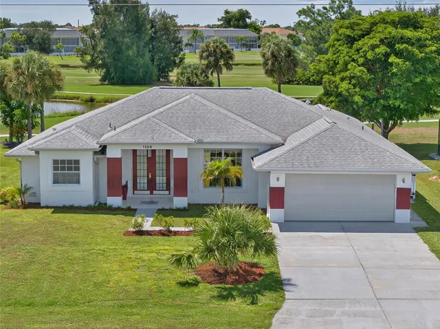 a aerial view of a house with swimming pool and a yard
