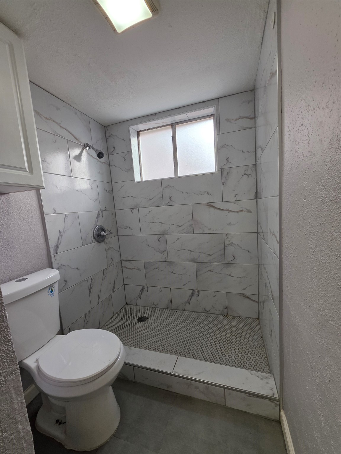 9611 Jaywood Street Houston, TX 77040 - Photo 13 of 22 a bathroom with a toilet and a shower