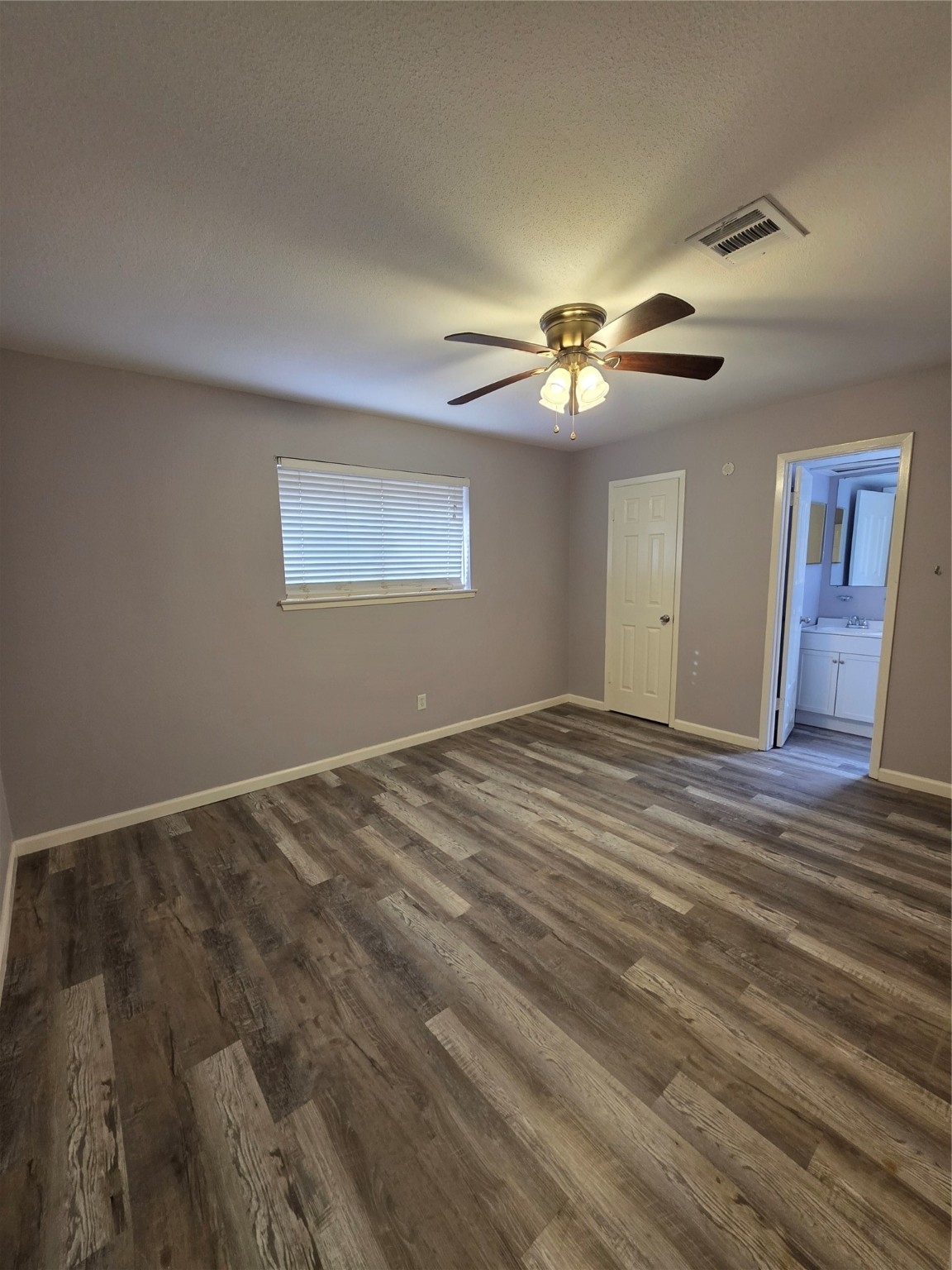 9611 Jaywood Street Houston, TX 77040 - Photo 15 of 22 a view of empty room with wooden floor and fan