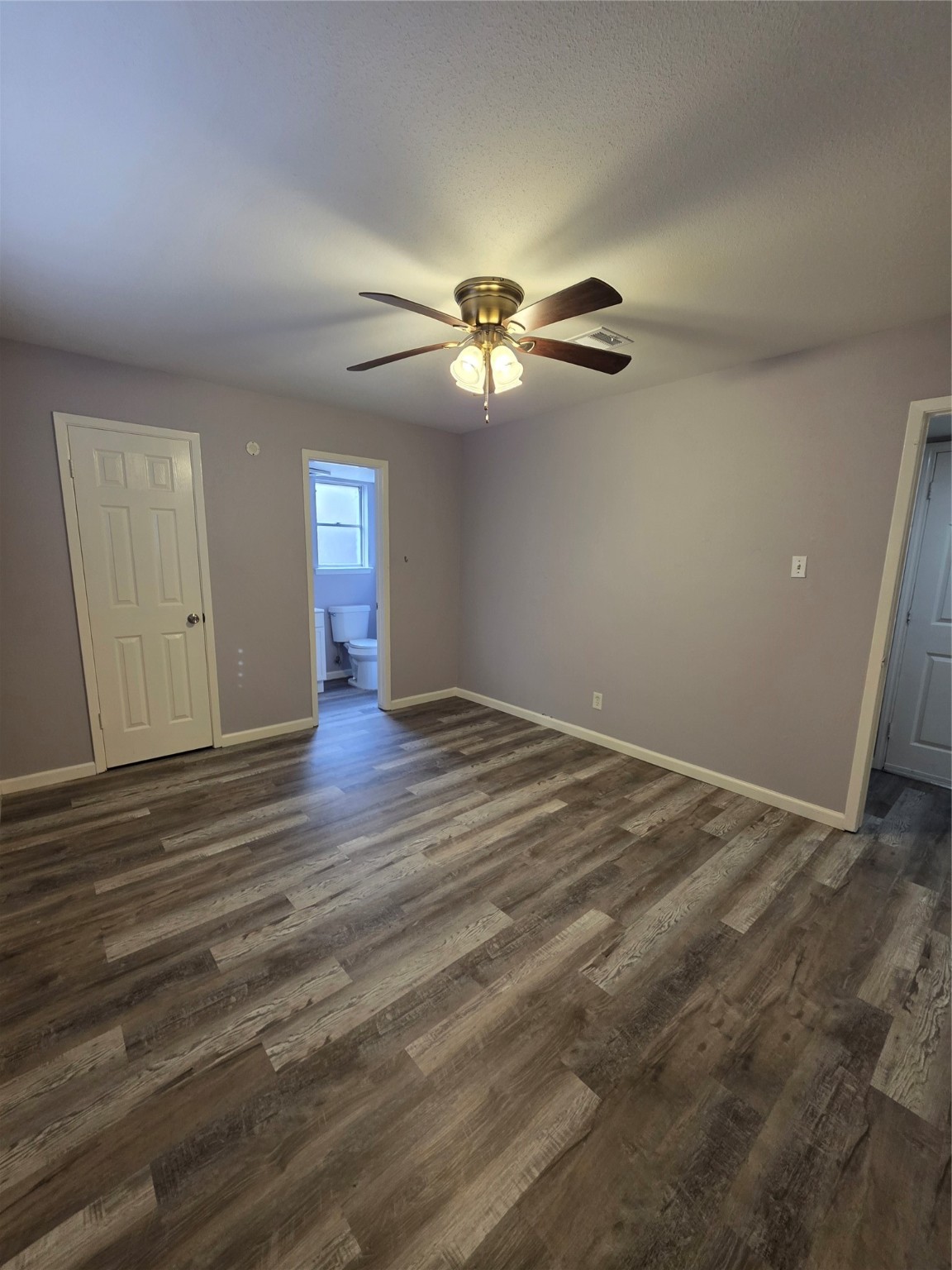 9611 Jaywood Street Houston, TX 77040 - Photo 16 of 22 a view of a room with wooden floor and ceiling fan