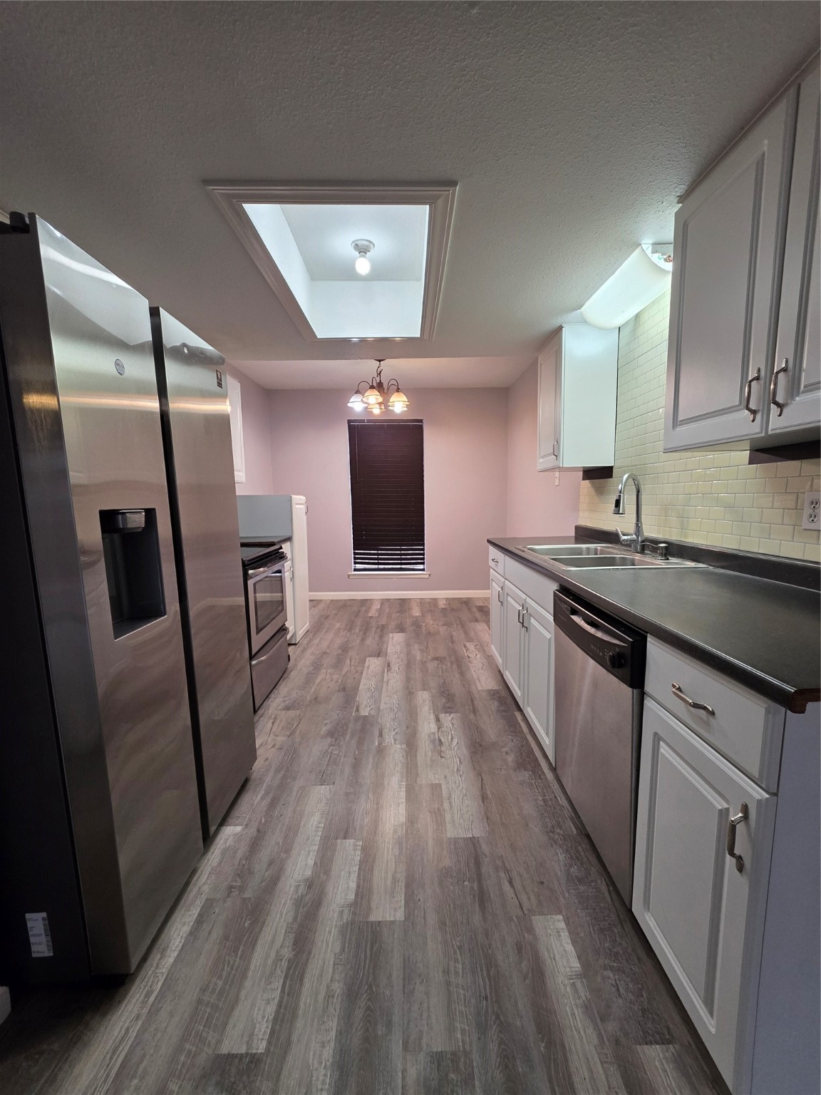 9611 Jaywood Street Houston, TX 77040 - Photo 4 of 22 a kitchen with granite countertop a sink appliances and cabinets