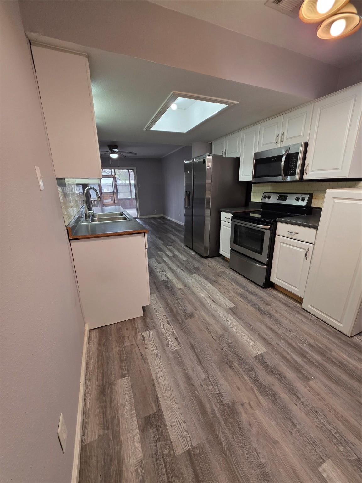 9611 Jaywood Street Houston, TX 77040 - Photo 6 of 22 a kitchen with granite countertop a sink cabinets and stainless steel appliances