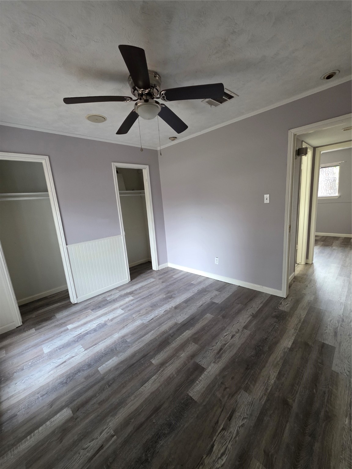 9611 Jaywood Street Houston, TX 77040 - Photo 8 of 22 a view of a big room with wooden floor cabinet and a ceiling fan