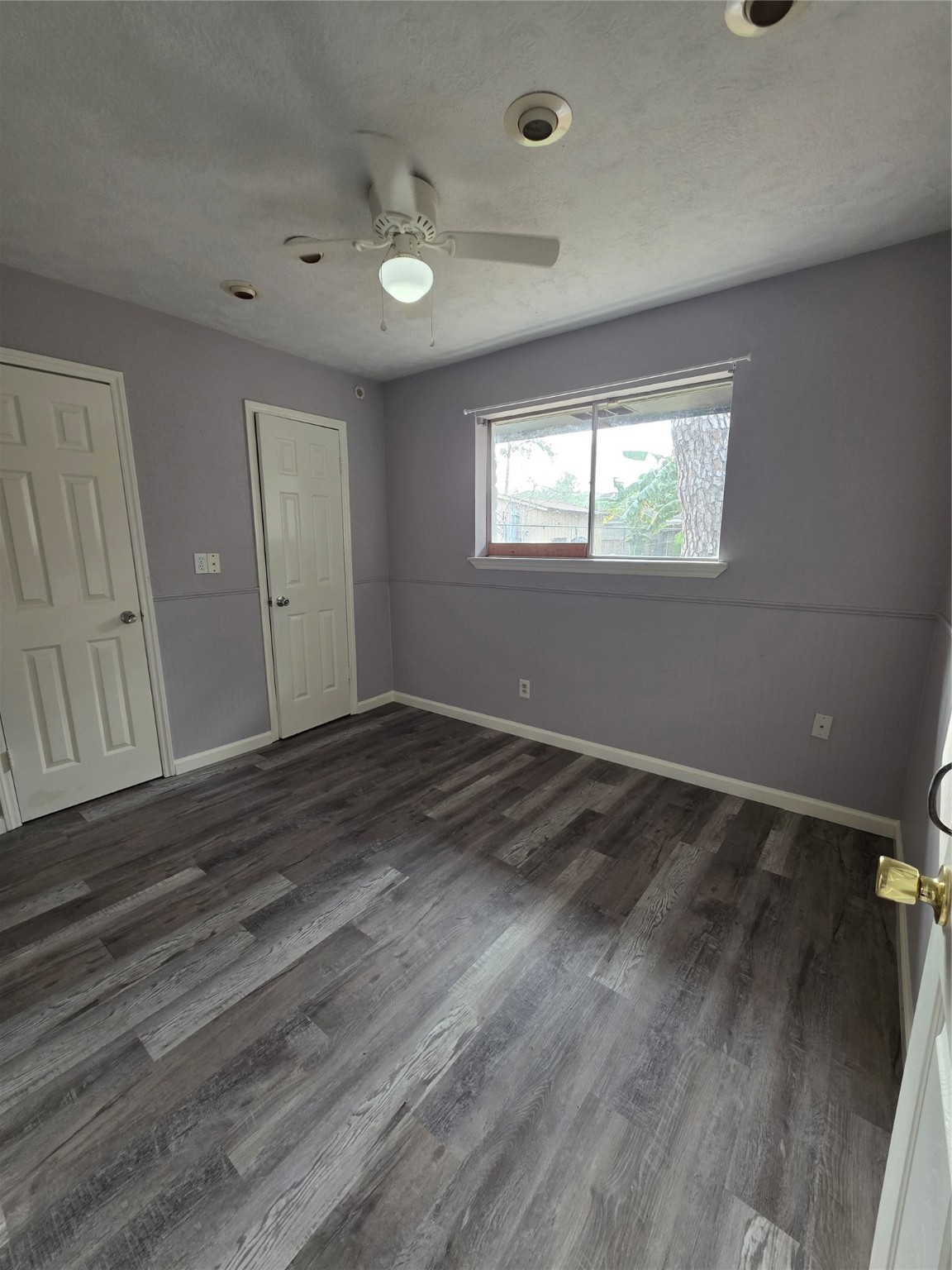 9611 Jaywood Street Houston, TX 77040 - Photo 9 of 22 an empty room with wooden floor and windows
