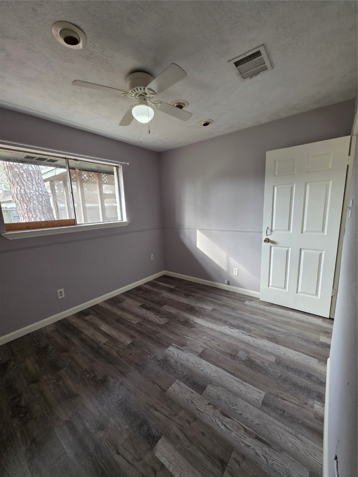 9611 Jaywood Street Houston, TX 77040 - Photo 10 of 22 a view of an empty room with wooden floor and a window
