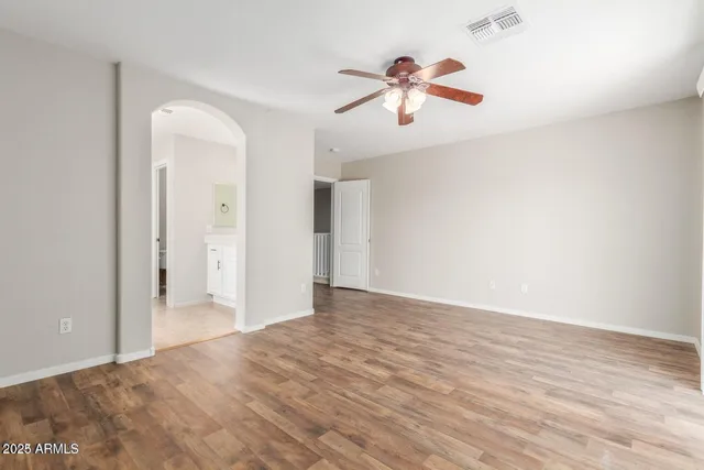 a view of empty room with wooden floor