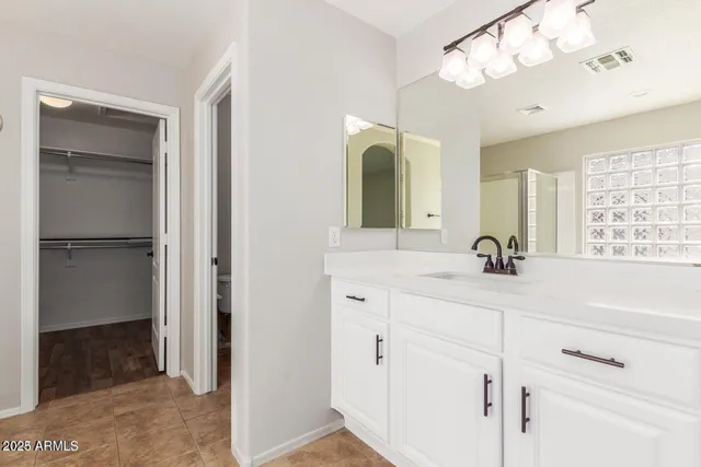 a bathroom with a double vanity sink a mirror and shower
