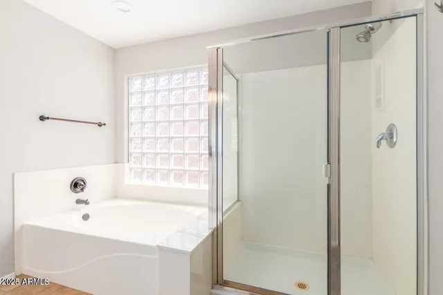 a bathroom with a bathtub and a shower