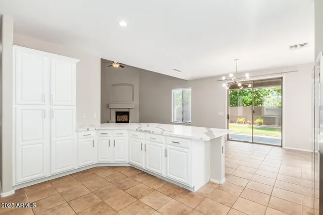 a spacious bathroom with a granite countertop sink a mirror and a bathtub
