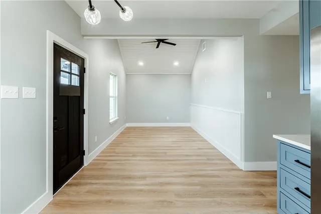 a kitchen with stainless steel appliances granite countertop a sink a stove and a refrigerator