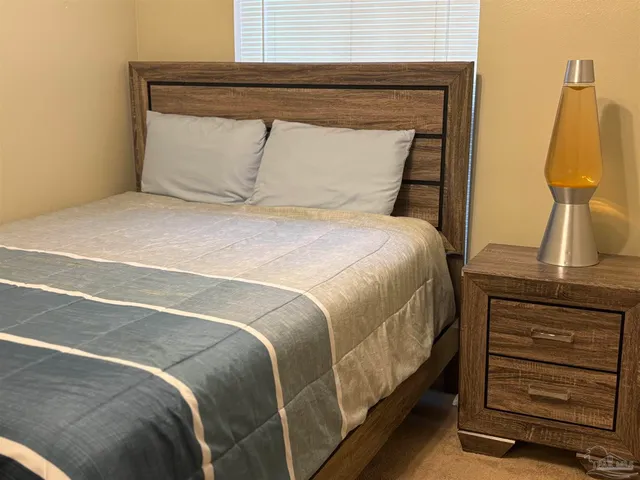 a bedroom with a bed and a mirror