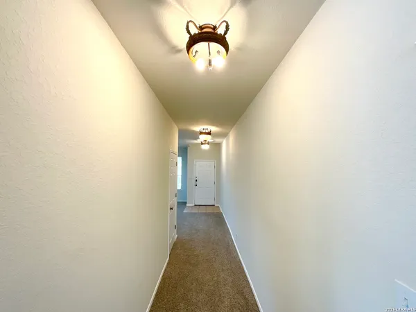 a view of a hallway with a chandelier