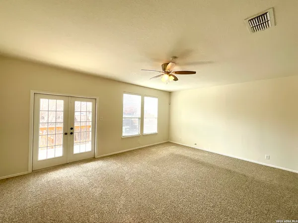 a view of an empty room with a window