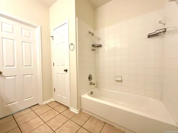 a bathroom with a bathtub and shower