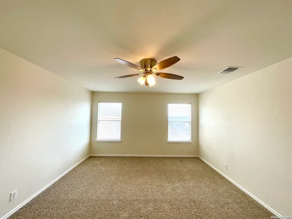 a view of room with window and ceiling fan
