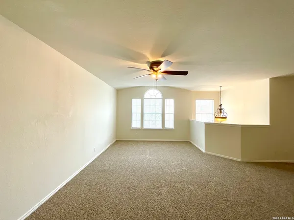 a view of a livingroom with a ceiling fan and window