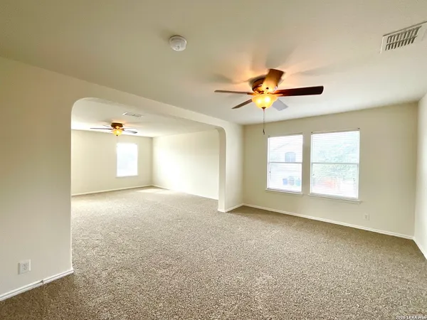 a view of a livingroom with a ceiling fan and window