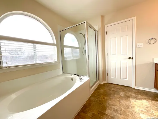 a spacious bathroom with a tub and shower