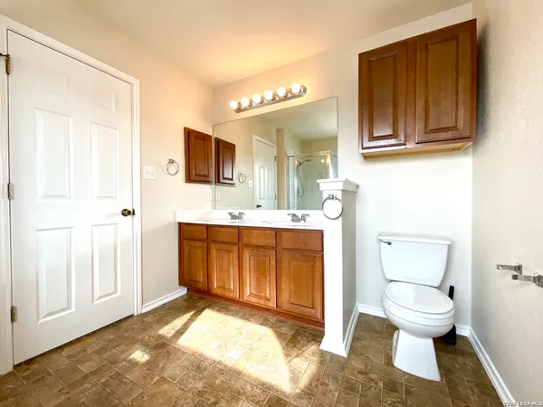a bathroom with a sink a toilet and mirror