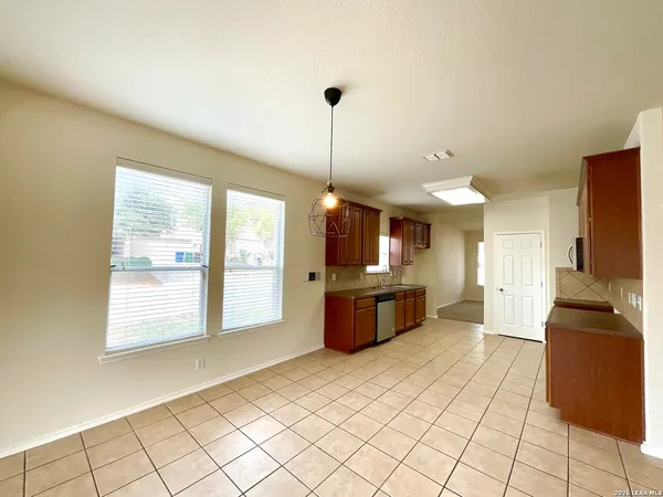 a large kitchen with sink cabinets and stainless steel appliances