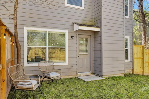 a backyard of a house with table and chairs