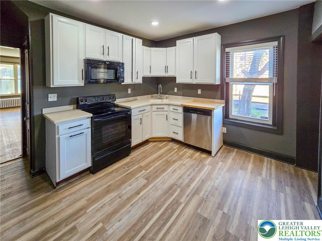 703 South Filmore Street Allentown, PA 18103 - Photo 4 of 15 a kitchen with a sink wooden floor and stainless steel appliances