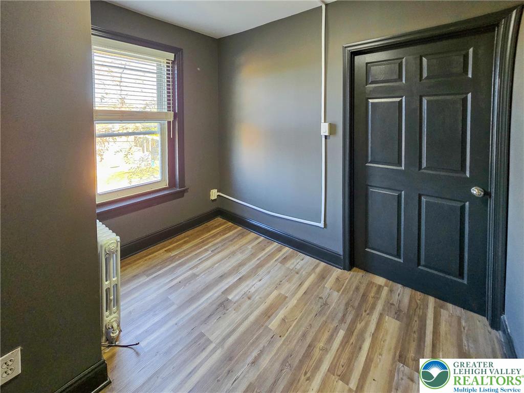 703 South Filmore Street Allentown, PA 18103 - Photo 8 of 15 a bedroom with a bed and wooden floor