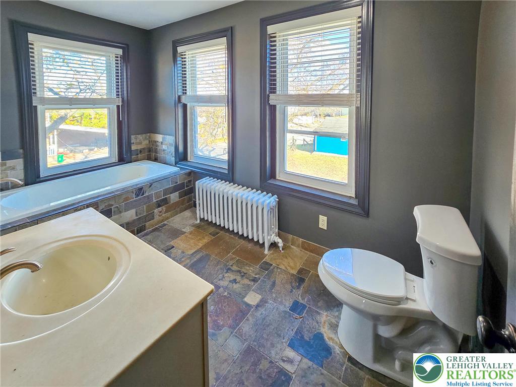 703 South Filmore Street Allentown, PA 18103 - Photo 9 of 15 a bathroom with a sink a toilet and a window