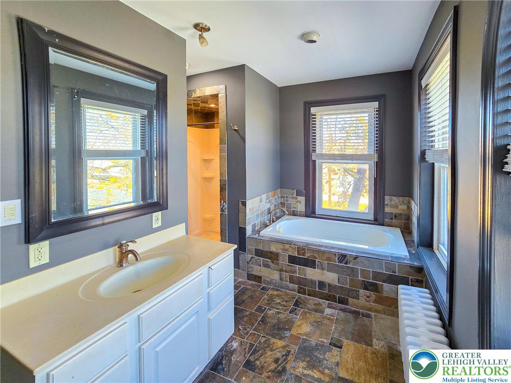 703 South Filmore Street Allentown, PA 18103 - Photo 10 of 15 a spacious bathroom with a tub sink and mirror