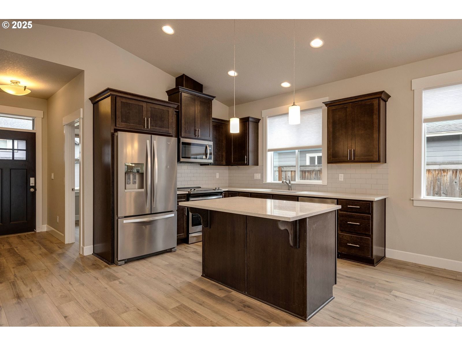 1099 Southeast Regan Hill Loop Estacada, OR 97023 - Photo 5 of 17 a kitchen with stainless steel appliances granite countertop a refrigerator a sink a stove a microwave and island