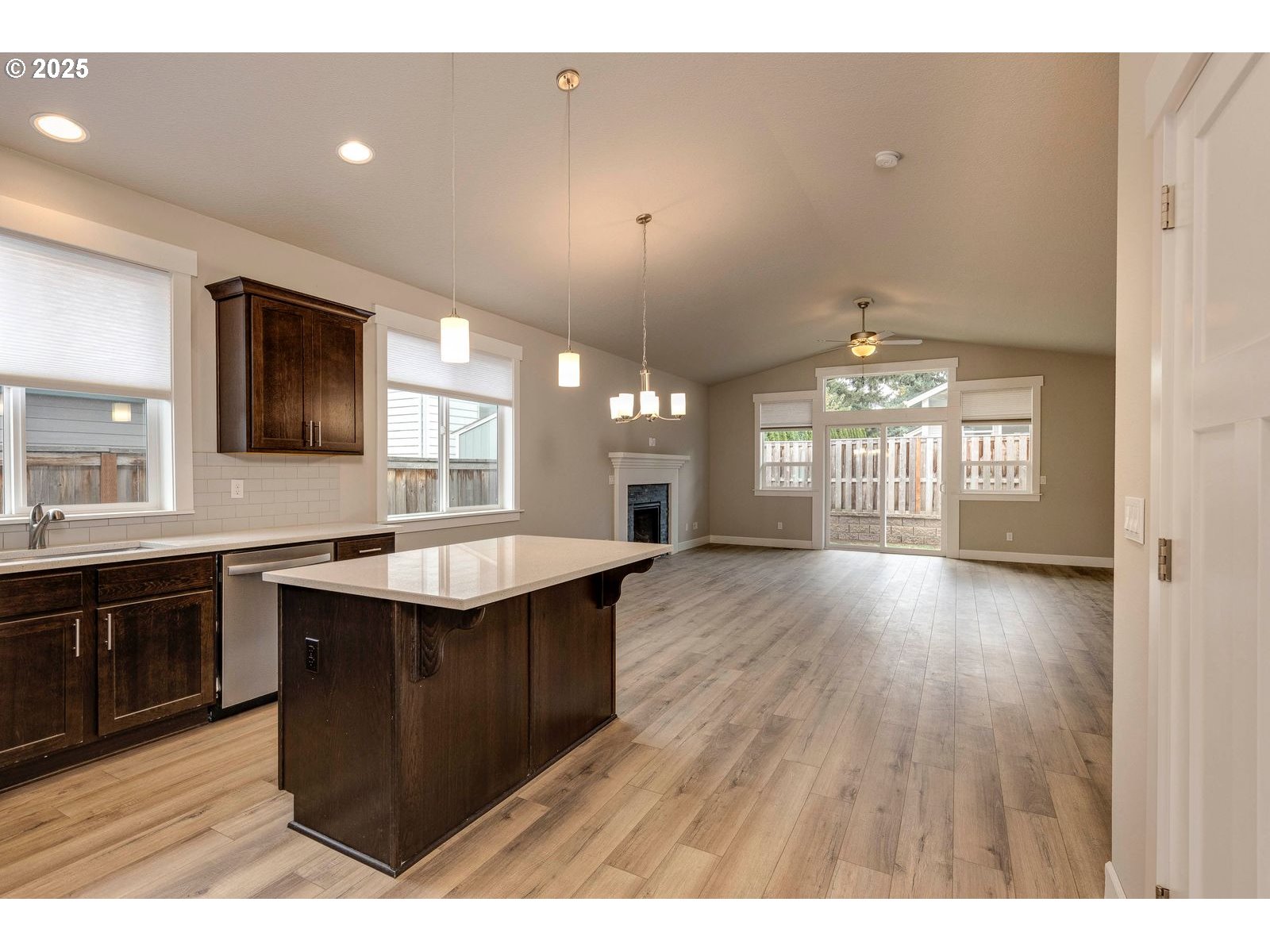 1099 Southeast Regan Hill Loop Estacada, OR 97023 - Photo 6 of 17 a kitchen with stainless steel appliances granite countertop a sink dishwasher a stove a dining table and chairs with wooden floor