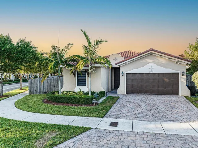 a front view of a house with a yard and garage