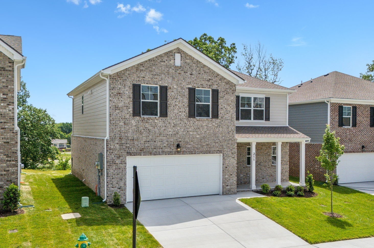 a front view of house with yard and green space
