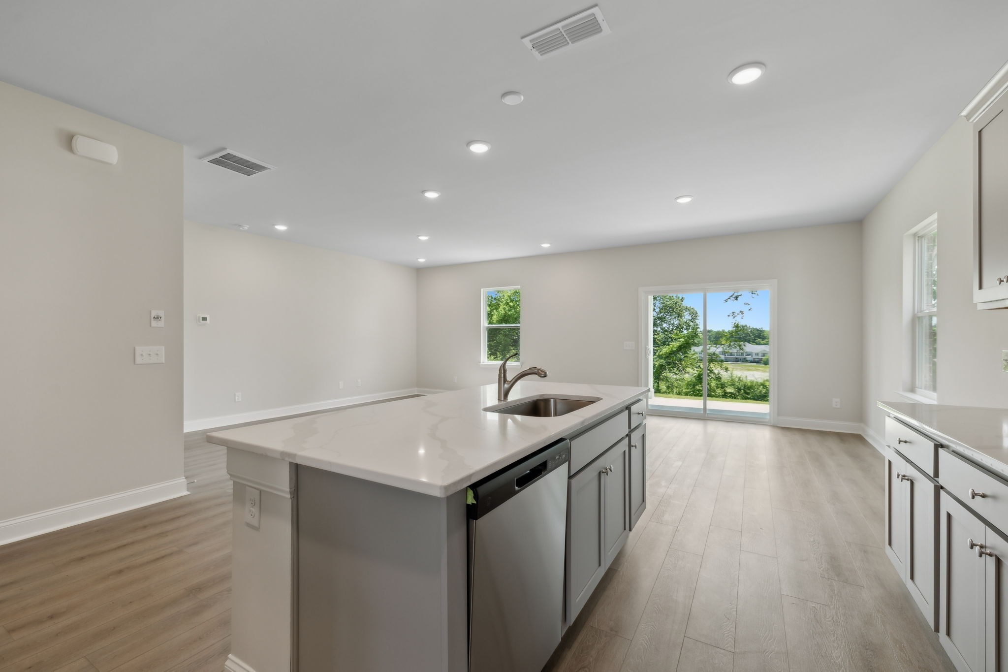 211 Limestone Way Mount Juliet, TN 37122 - Photo 16 of 35 a kitchen with a sink a counter top space and living room