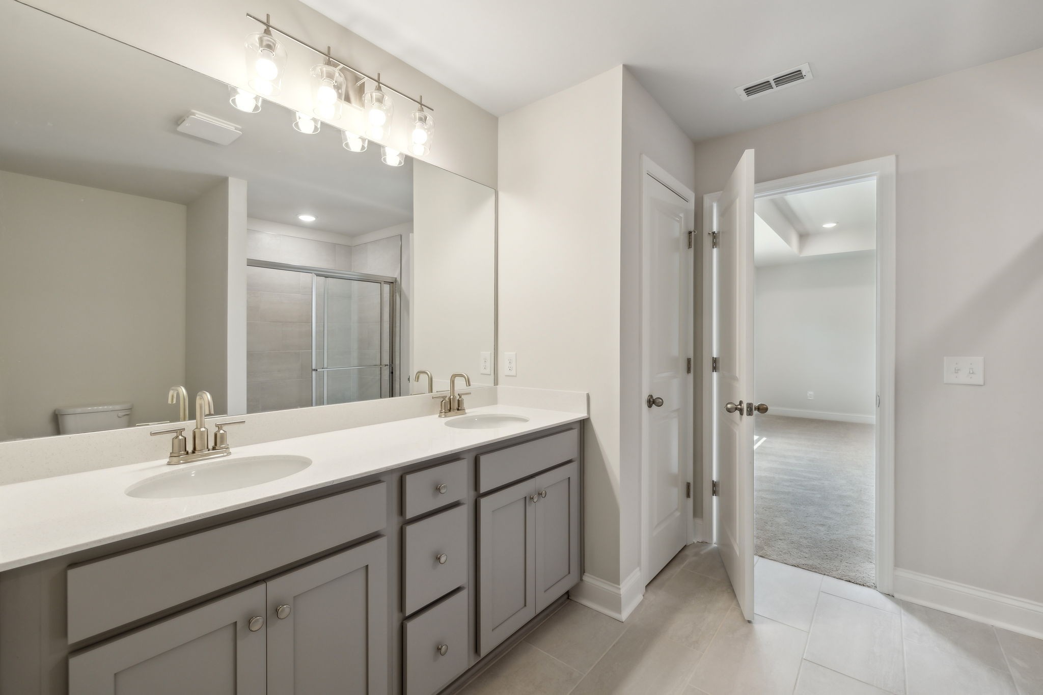 211 Limestone Way Mount Juliet, TN 37122 - Photo 23 of 35 a bathroom with a double vanity sink mirror and shower