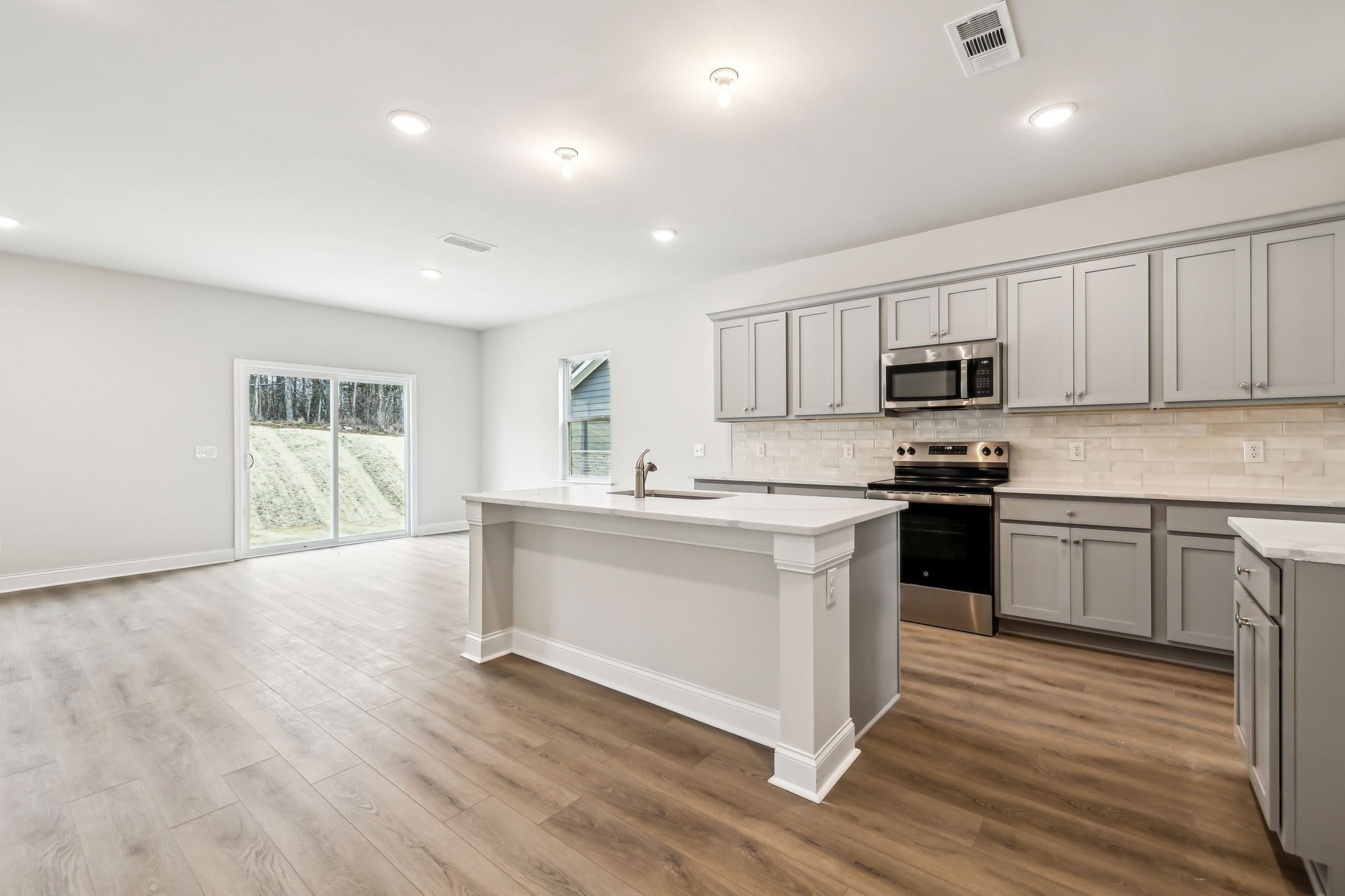 211 Limestone Way Mount Juliet, TN 37122 - Photo 4 of 35 a kitchen with sink a microwave and cabinets