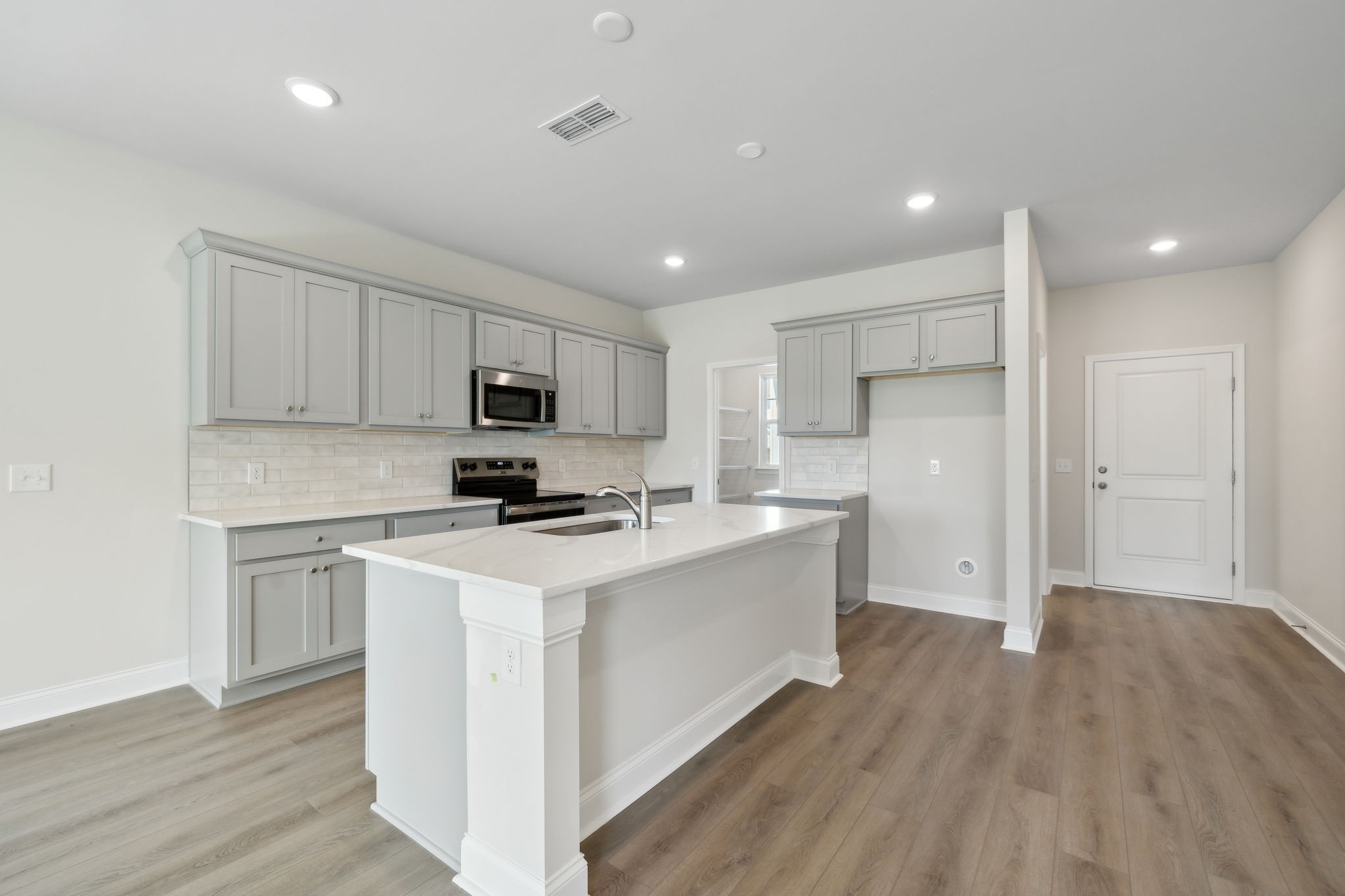 211 Limestone Way Mount Juliet, TN 37122 - Photo 6 of 35 a kitchen with stainless steel appliances granite countertop a sink stove and refrigerator
